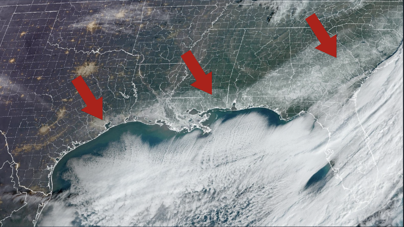 Arrows point to white ground cover seen from space along the coastline of the Gulf of Mexico.