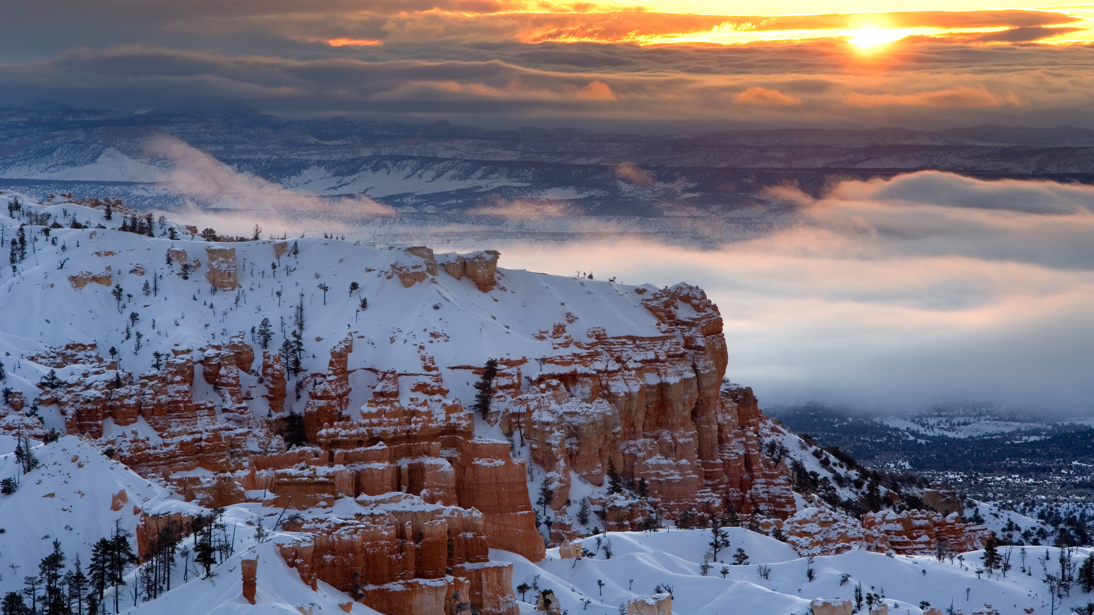 Sunrise over misty clouds hanging in the valley of Bryce Canyon National Park.