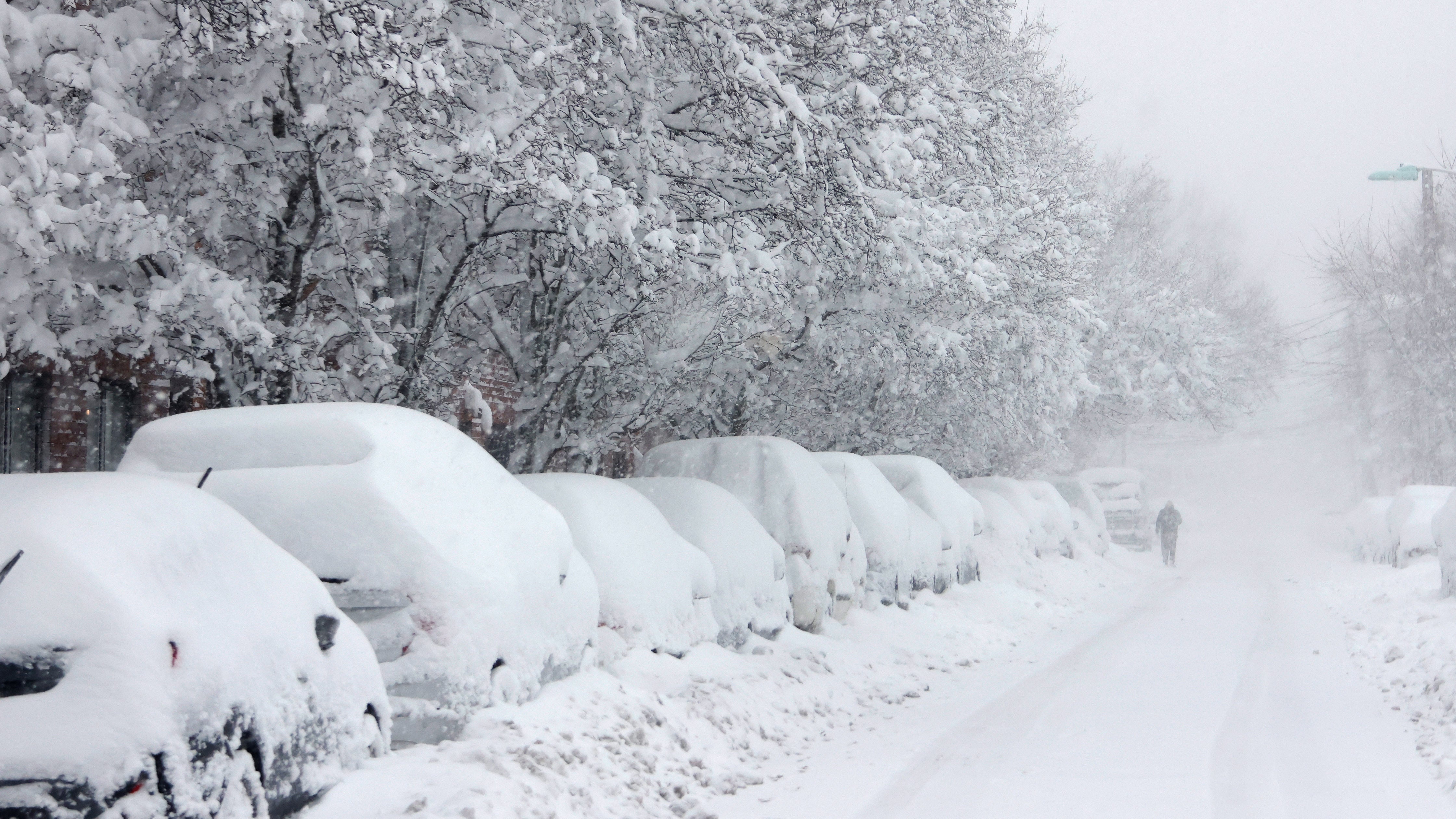 A person walks down a snow-covered street in Hoboken, New Jersey as a major winter storm hits the Northeast and Mid-Atlantic regions, bringing heavy snowfall.