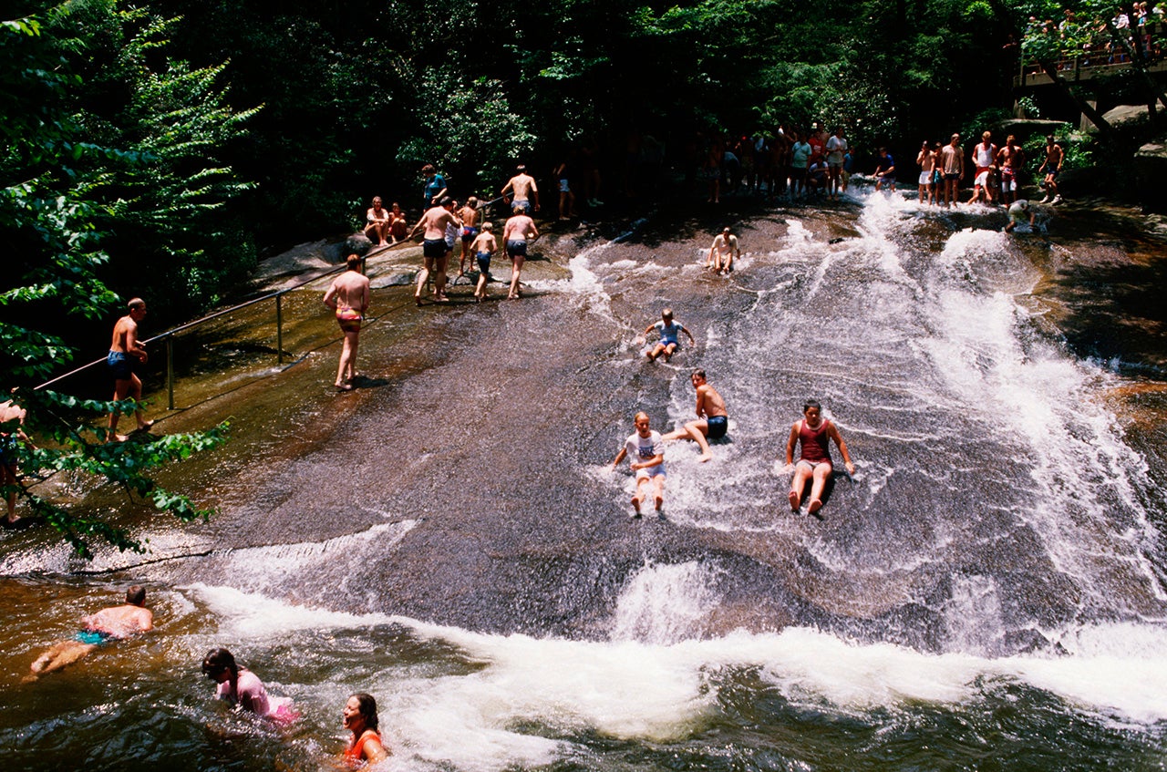 People enjoy sliding down the natural rock waterslide at Pisgah National Forest in North Carolina. 