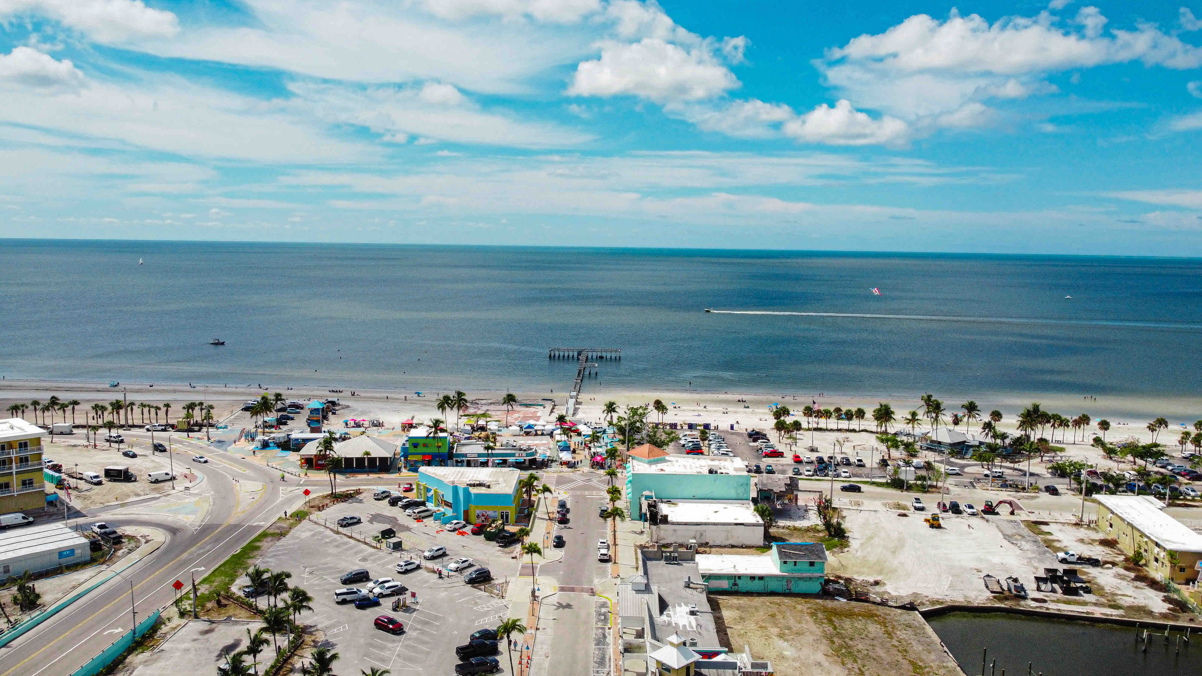 An aerial view of buildings and blue ocean water.