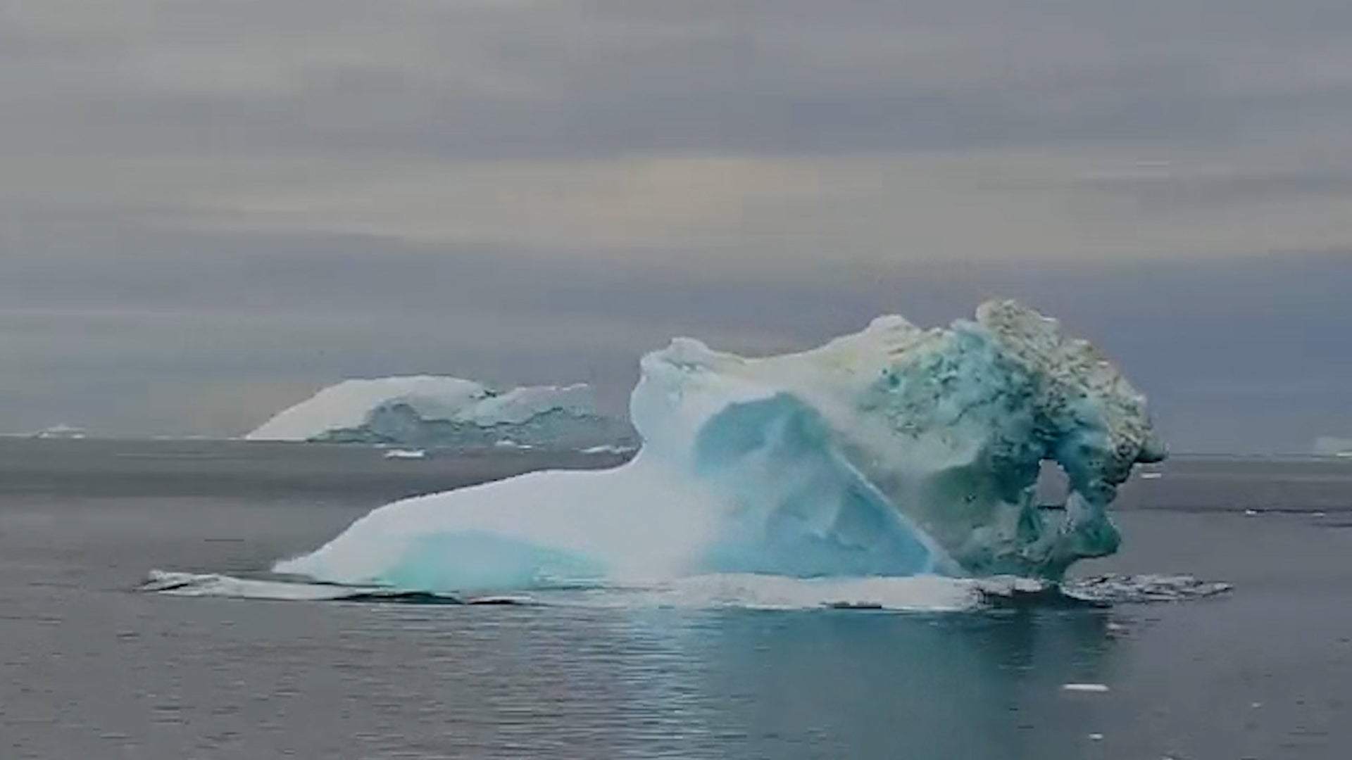 Huge Iceberg Shaped Like A Snail Topples Over Off Greenland