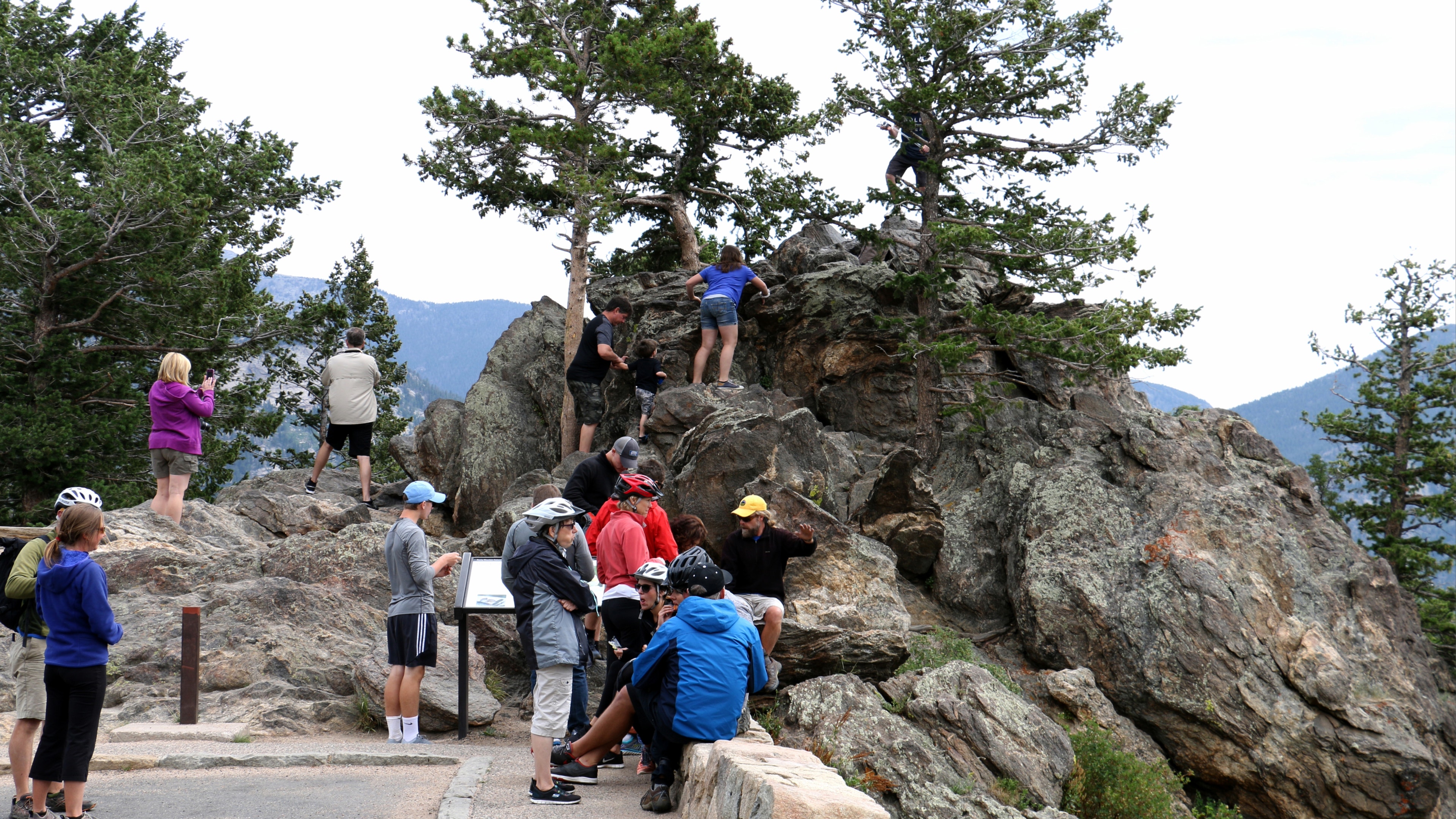 Visitors climbing at a lookout point along trailridge road in Rocky Mountain National Park