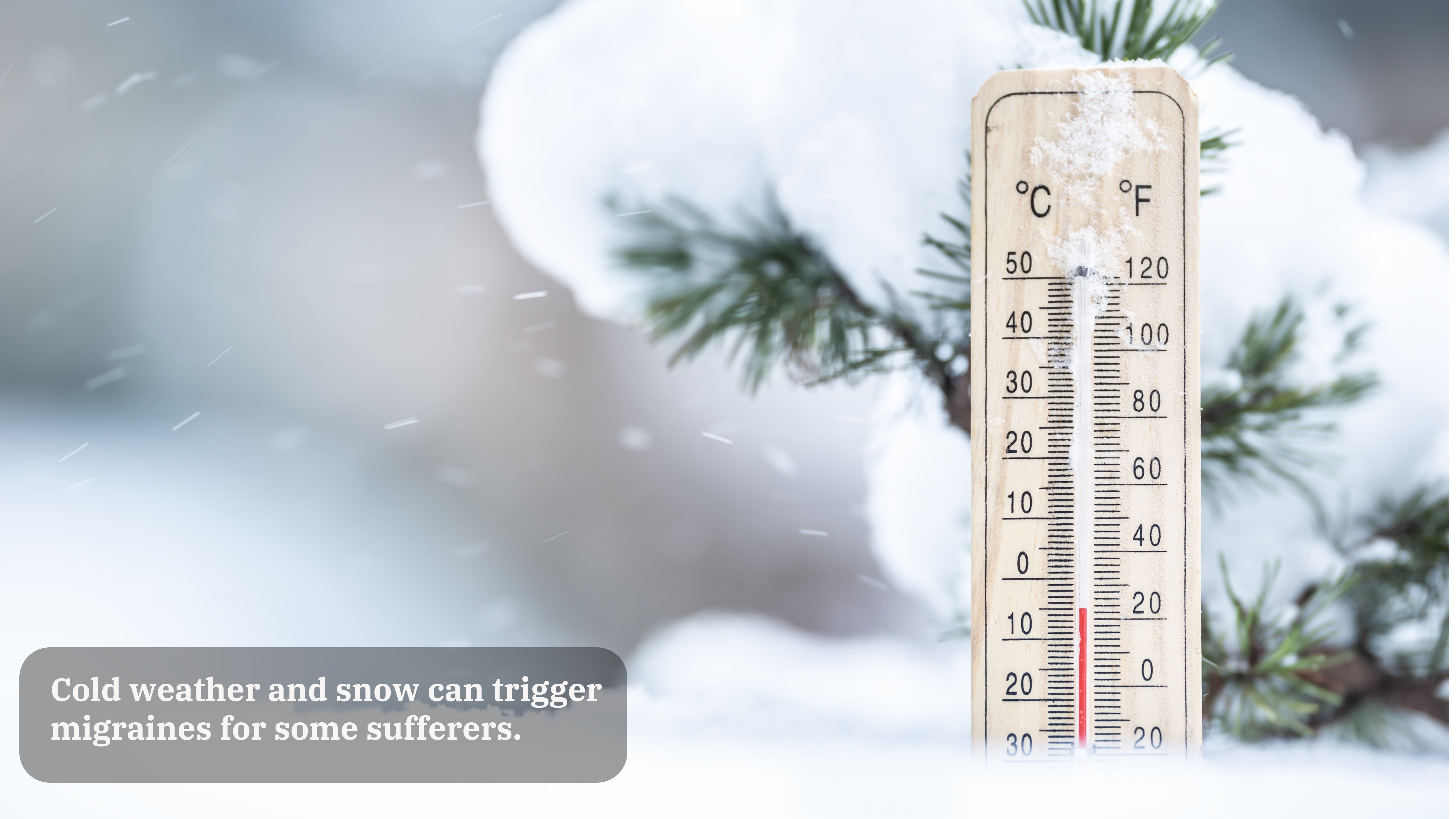 A thermometer is seen in snow with a snowy branch in the background. A caption on the image reads "Cold weather and snow can trigger migraines for some sufferers."