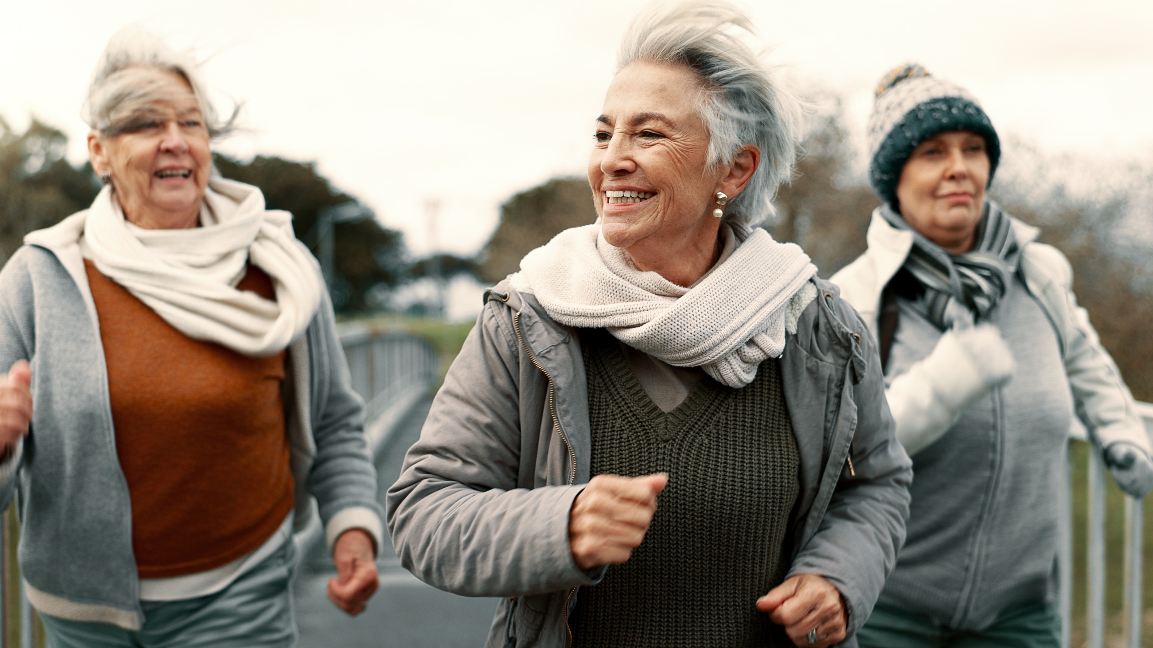 Senior friends, women and walking with fitness, exercise and fresh air with happiness, wellness and health. Female people, mature ladies and group with speed walk, training and energy with freedom