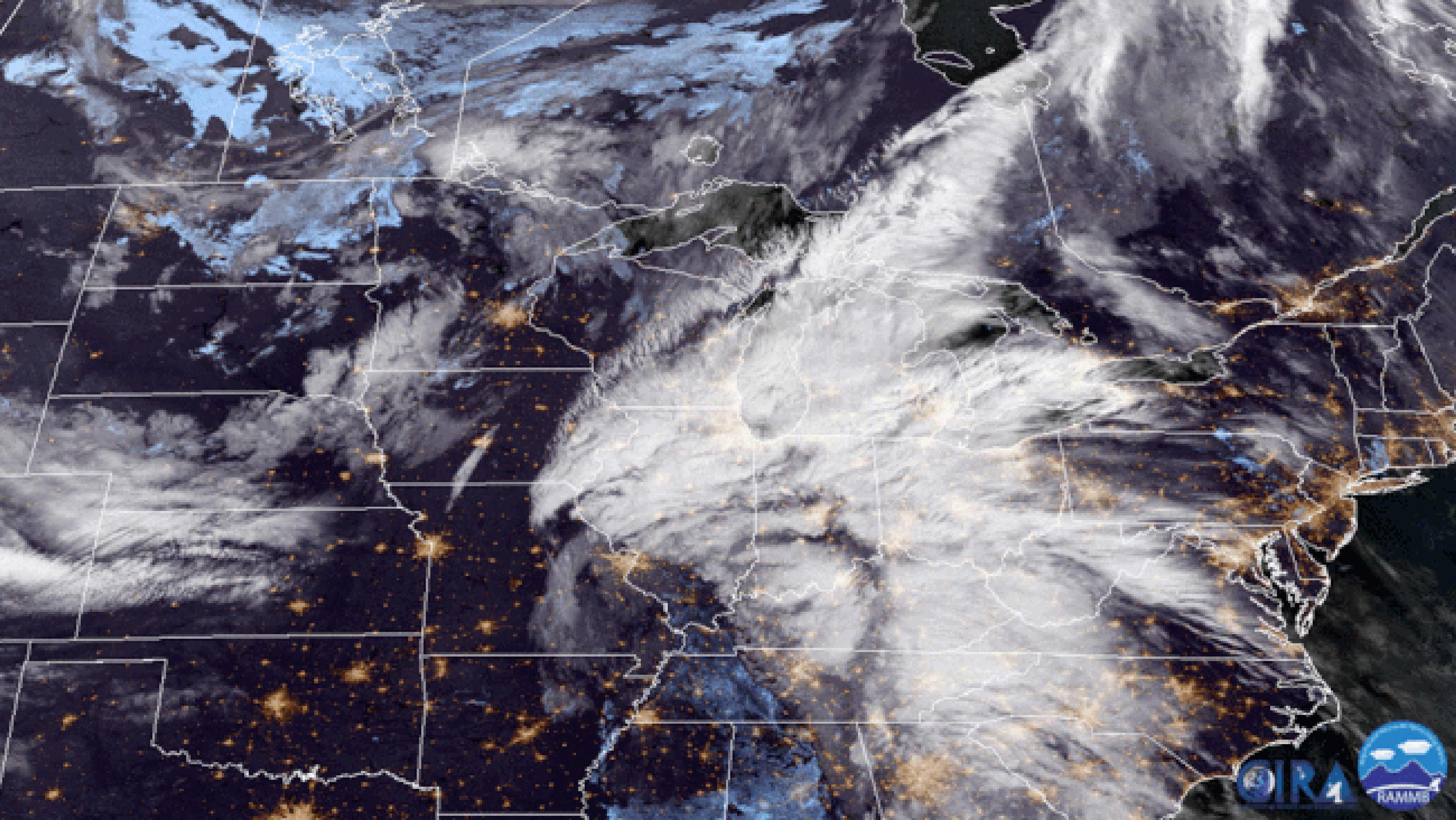 GOES-16 GeoColor satellite images taken at 8 a.m. EDT, Oct. 23, 2017 (first image), then 24 hours later, showing the bombogenesis of a Great Lakes storm. (Note: City lights overlay is applied in these images.)  (CIRA-RAMMB)