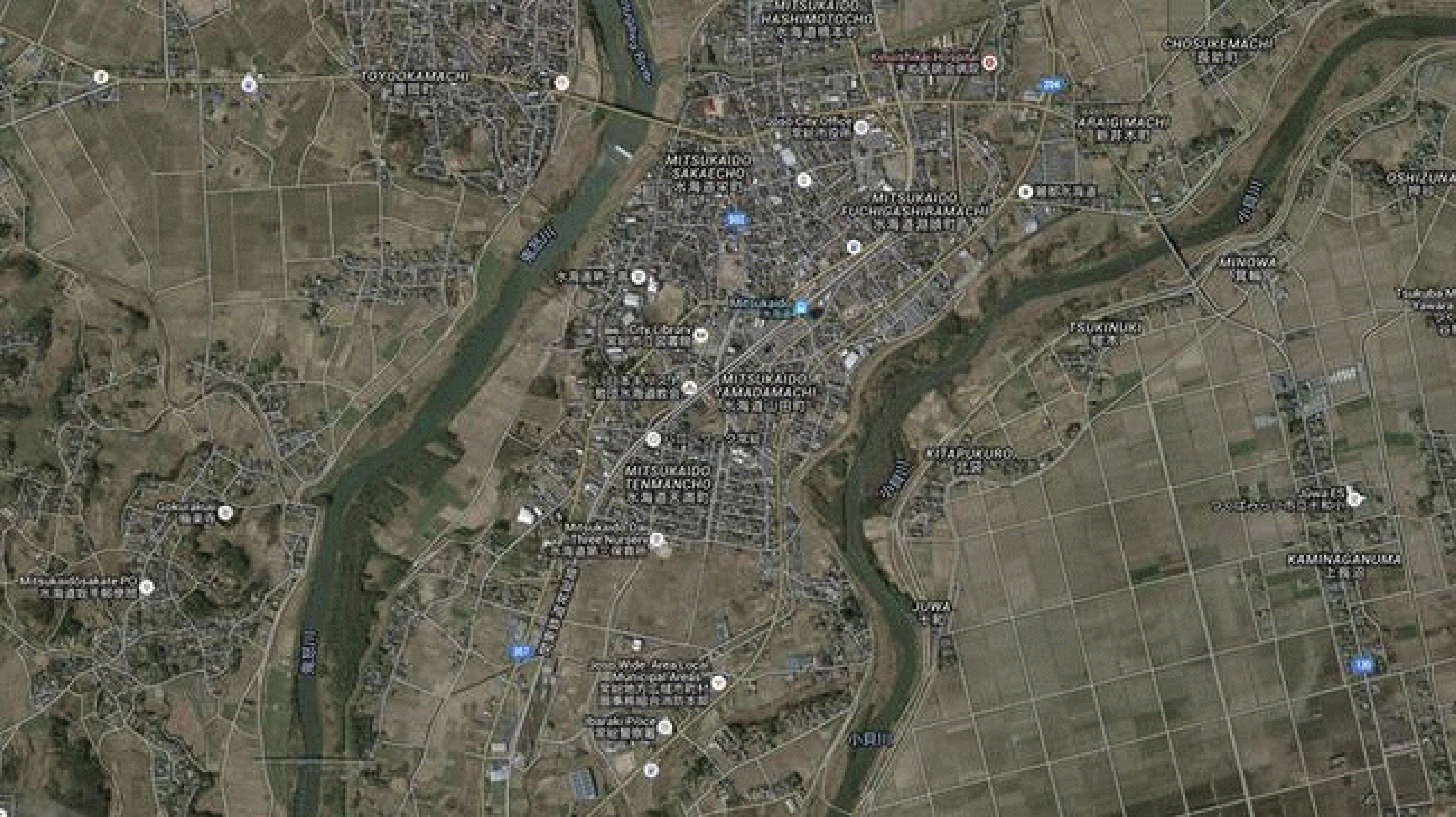 A wide view of the flooded city of Joso, Japan, visible by light-tan-colored water in the after satellite image of the loop above on September 11, 2015.