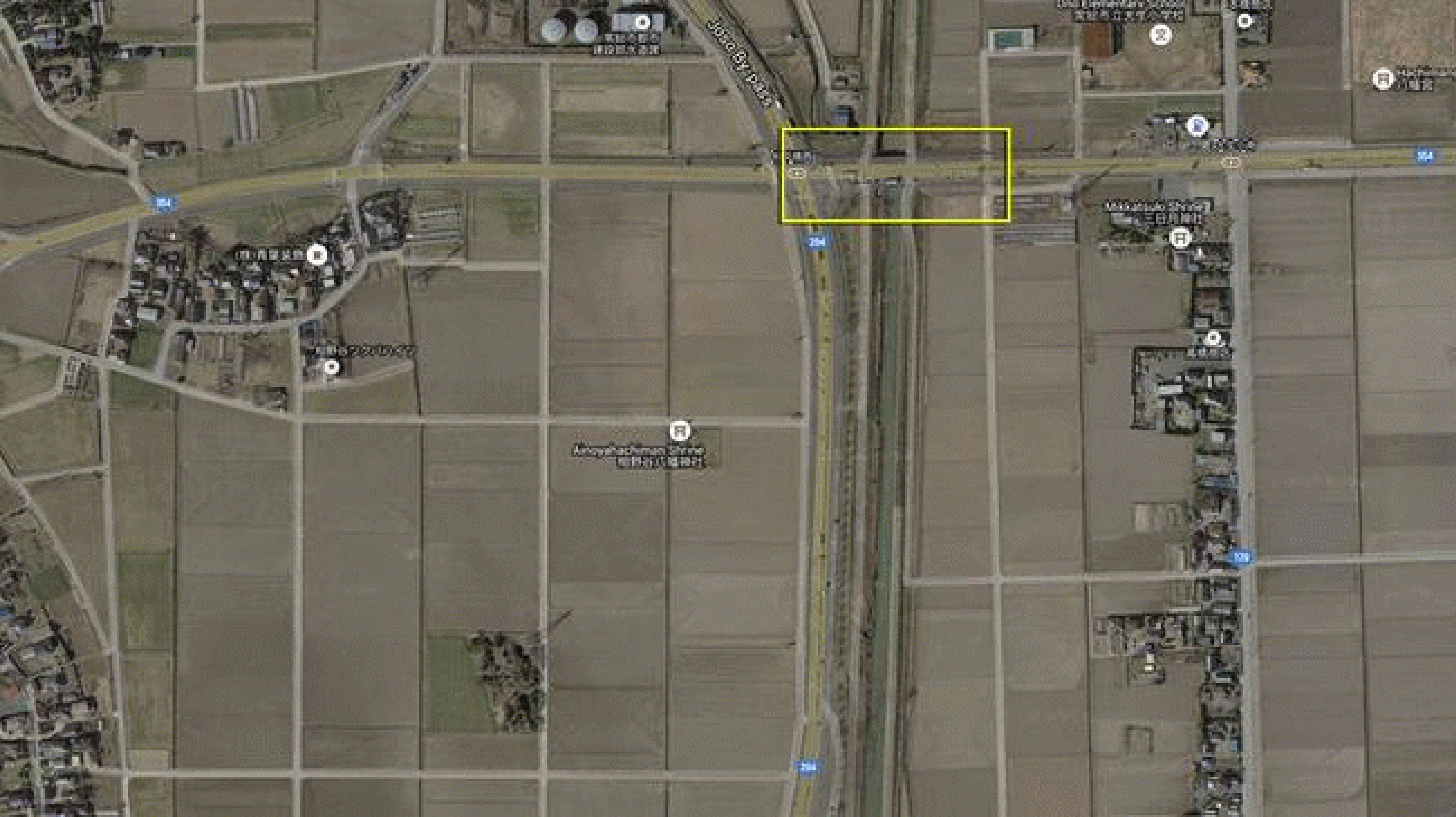 Flooded lowlands northeast of the city of Joso, Japan on September 11, 2015. The Joso By-pass (highway 294) runs north to south in the center of the images. The yellow box highlights vehicles parked on a bridge surrounded by floodwater. 