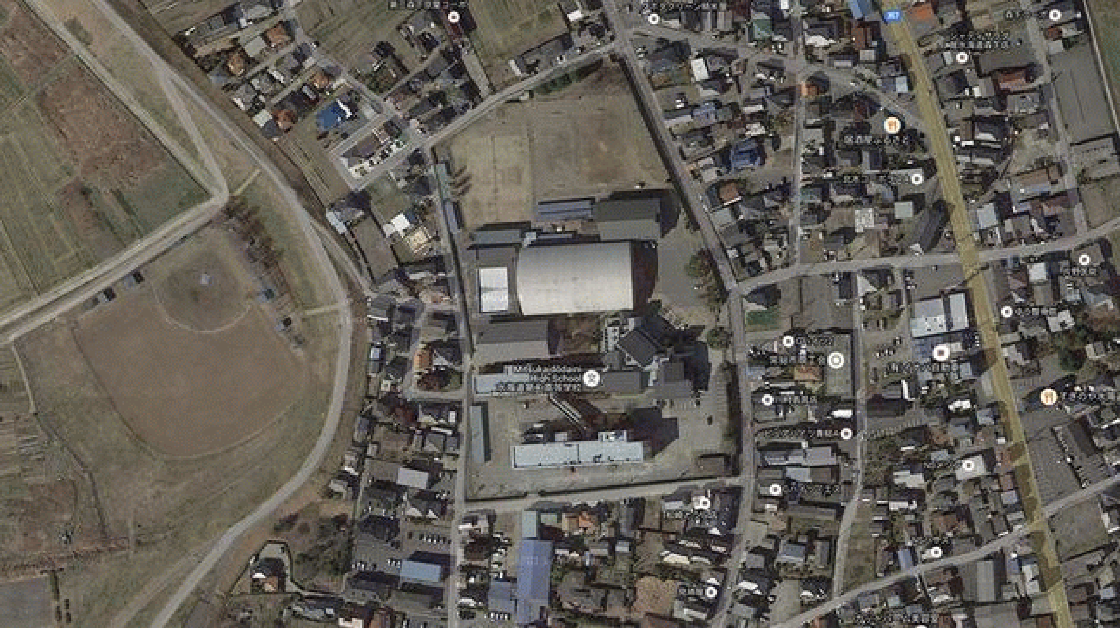 View of the flooded Mitsukaidodaini High School property (building with curved roof in center of the images) in the city of Joso, Japan, on September 11, 2015. Note also the flooded baseball diamond in the left-center of the image loop. 