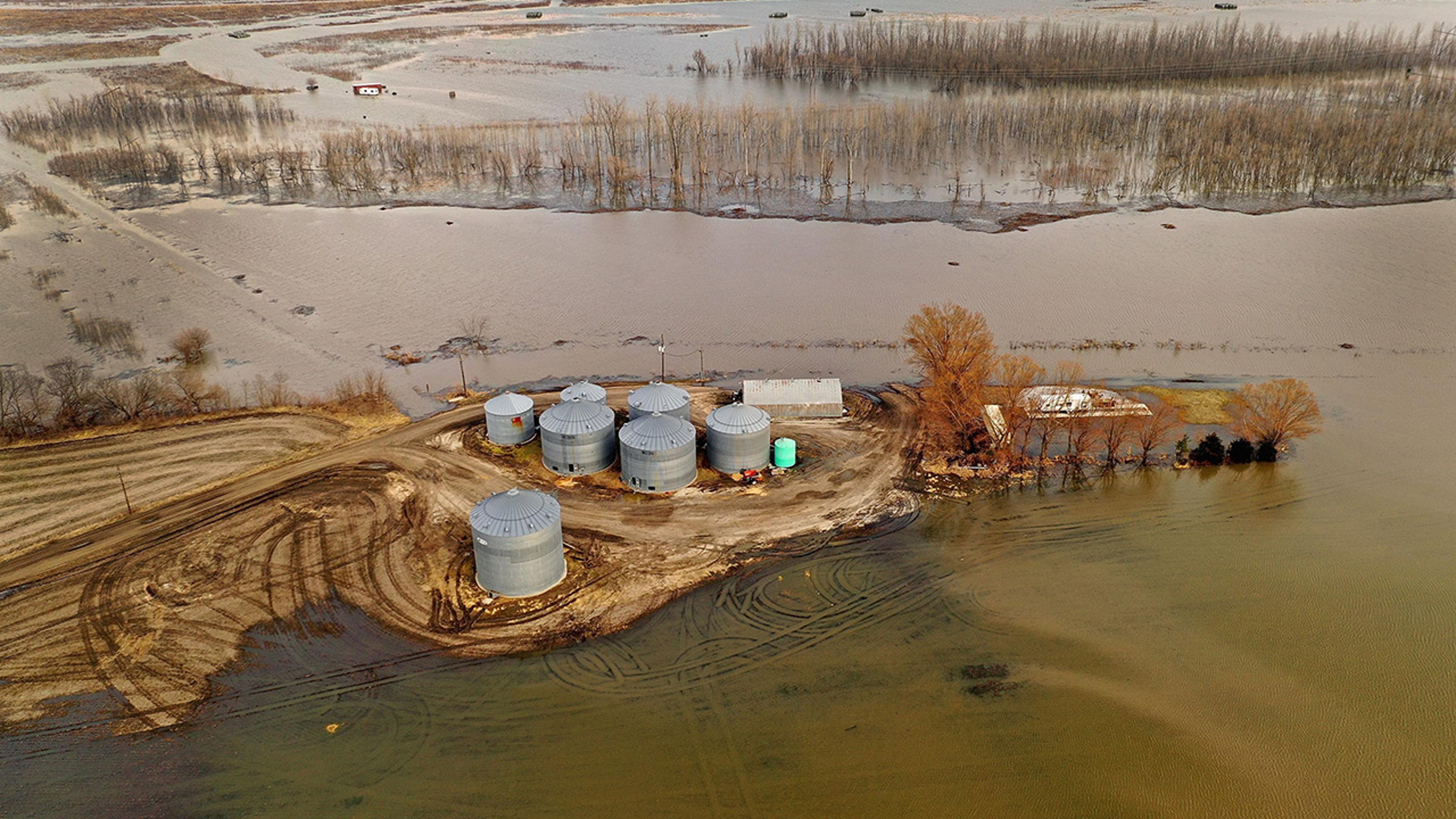 Floodwater recedes from around grain silos on March 23, 2019, near Nemaha, Nebraska.