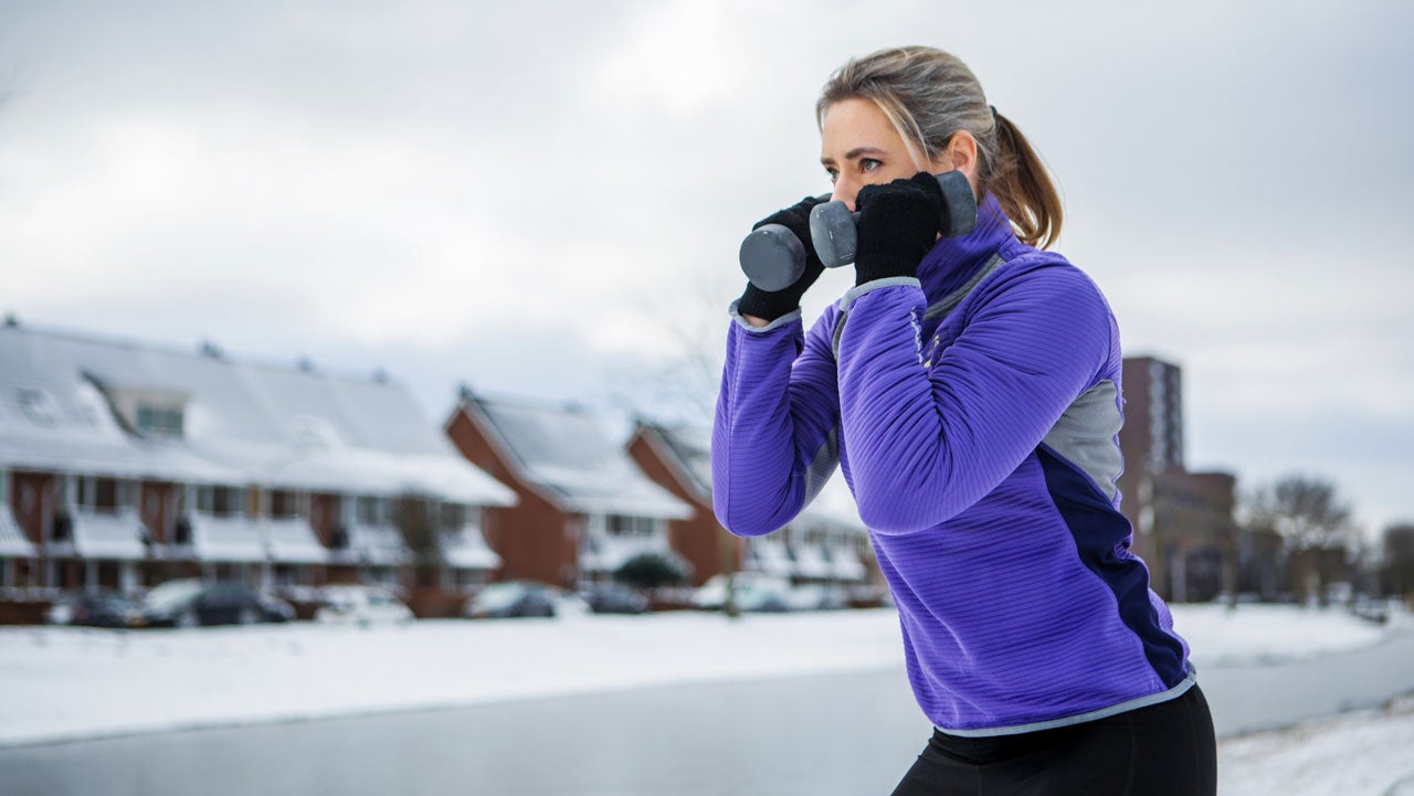 woman in winter using weights