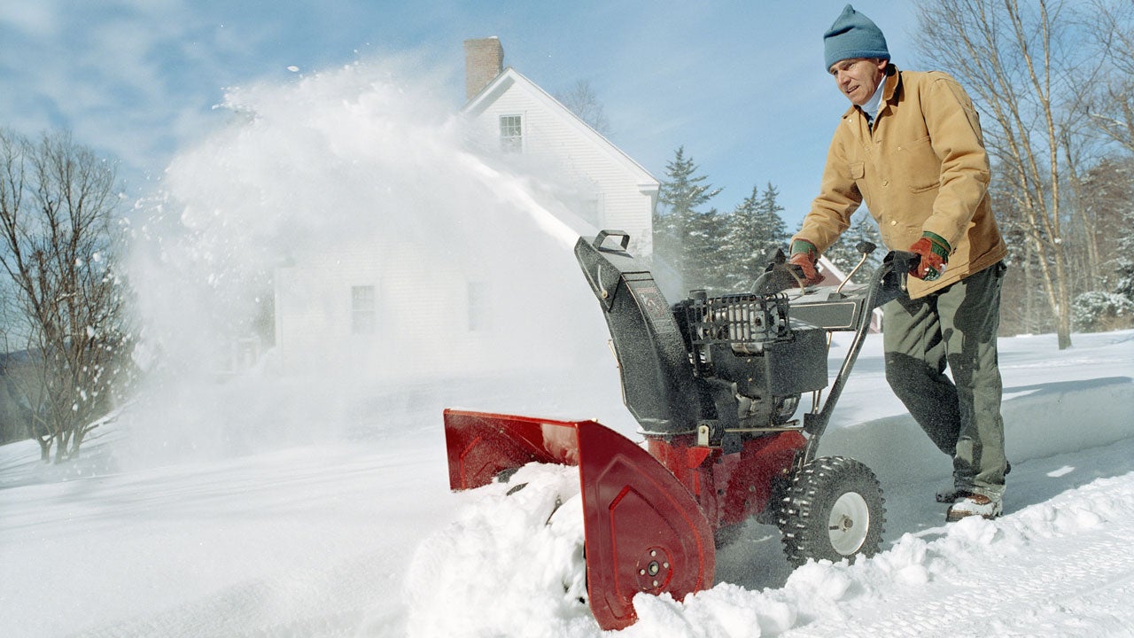 Man using snow thrower