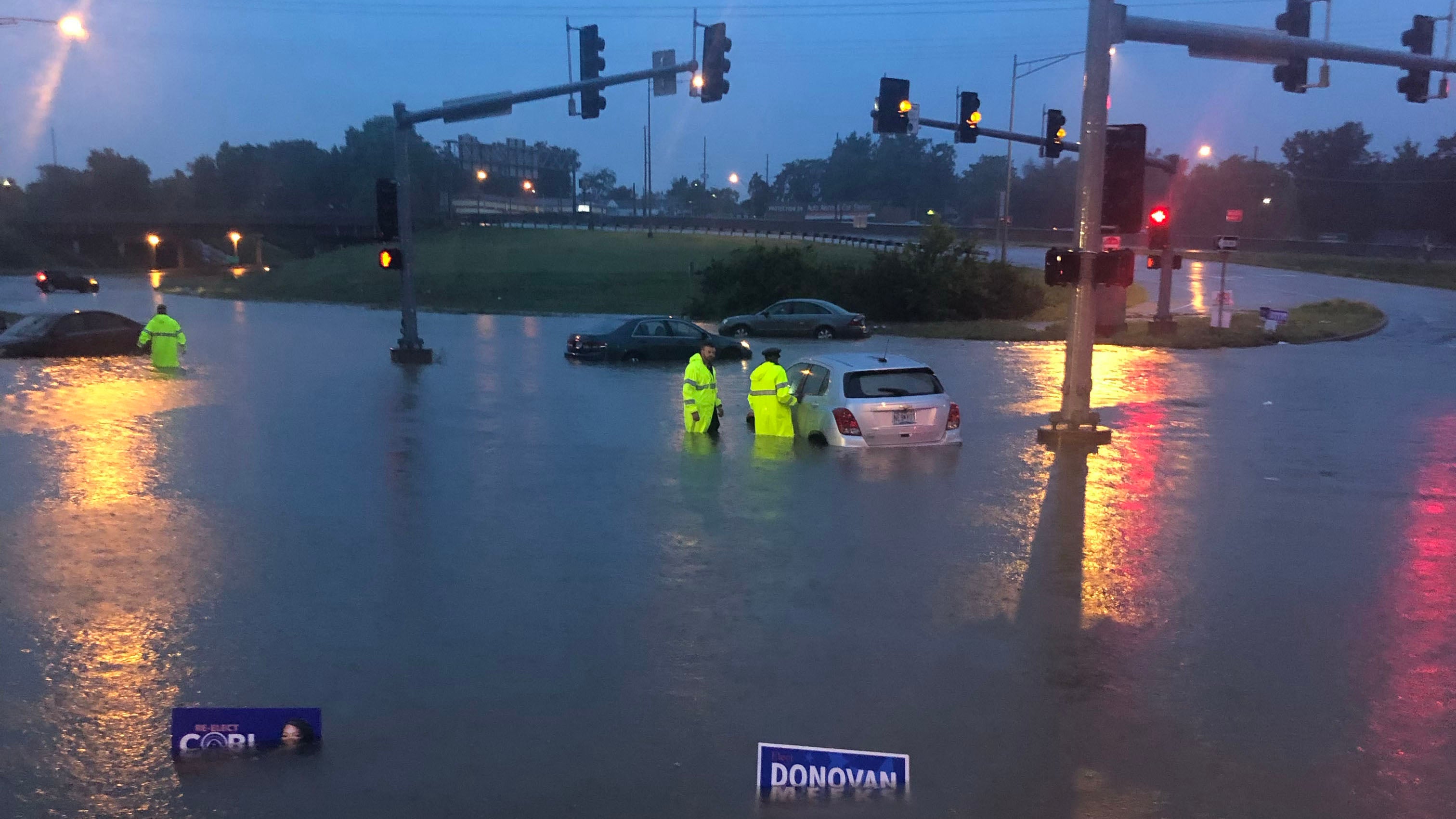 Two Jennings Precinct officers rescue a motorist from floodwaters at Jennings Crossing and Jennings Station Road in St. Louis, Mo., on Tuesday, July 26, 2022. (Twitter/St. Louis County PD)