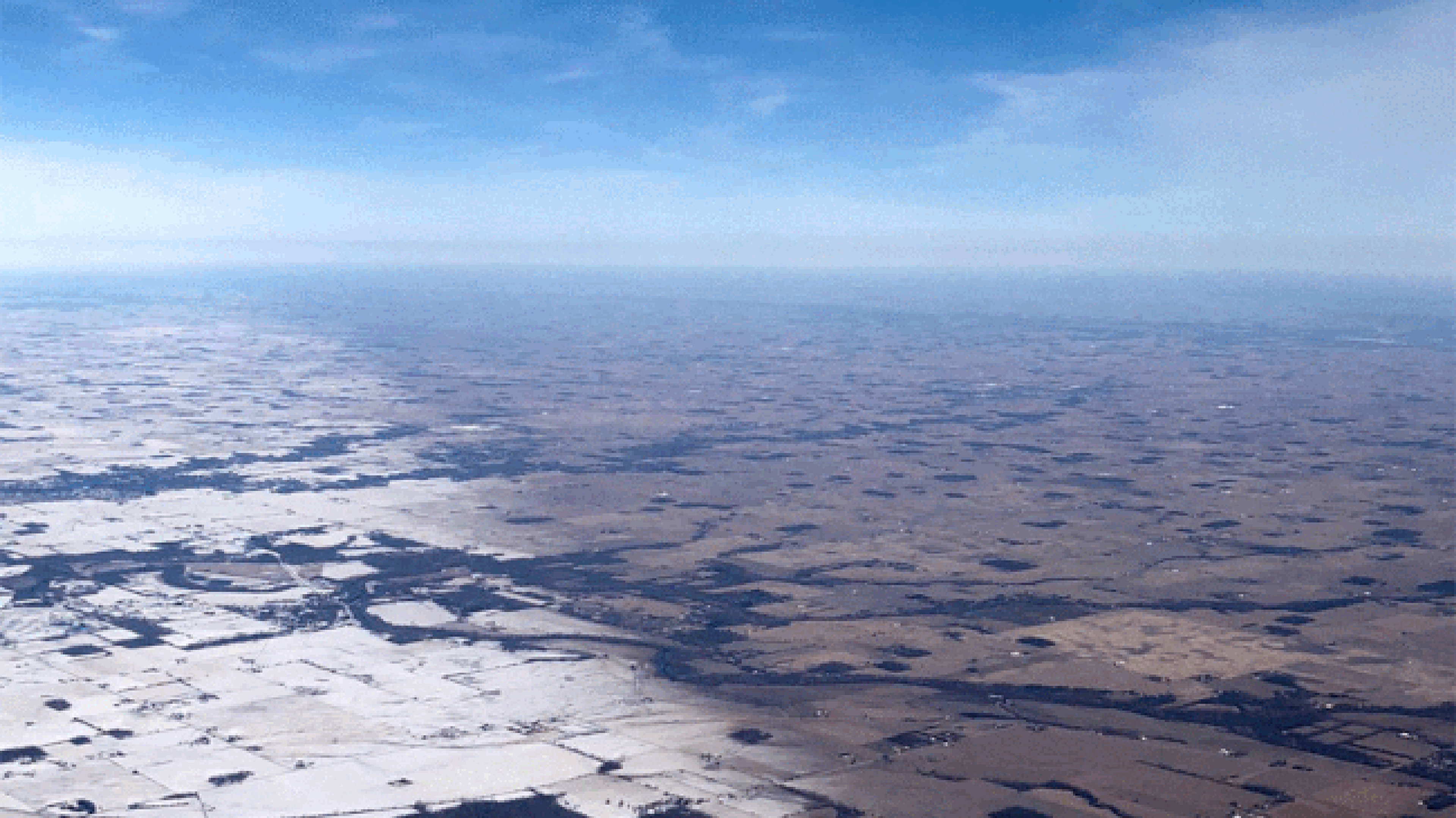 The edge of Winter Storm Uma's snow cover near Indianapolis, as seen from the window seat of a flight on March 25, 2018. Yellow arrows highlight the boundary marking the extent of snow cover that fell from Uma.