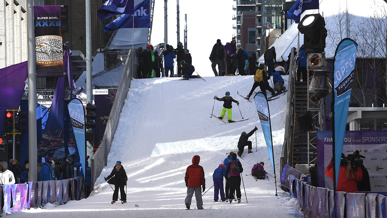 Fans on a makeshift ski slope ski in cold weather during the Super Bowl LIVE, a 10-day fan festival leading up to Super Bowl LII, taking place on Minneapolis' Nicollet Mall in Downtown Minneapolis, Minnesota February 2, 2018. Tom Brady will attempt to write another chapter of NFL history on Sunday as the New England Patriots chase a record-equalling sixth Super Bowl crown against a Philadelphia Eagles team desperate for their first ever win. (Photo by TIMOTHY A. CLARY / AFP) (Photo by TIMOTHY A. CLARY/AFP via Getty Images)          