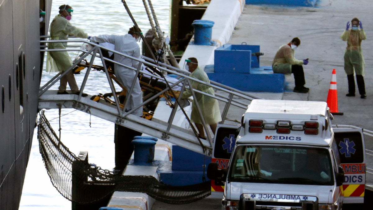 A person on a stretcher is removed from Carnival's Holland America cruise ship Zaandam at Port Everglades during the new coronavirus pandemic, Thursday, April 2, 2020, in Fort Lauderdale, Fla. Those passengers that are fit for travel in accordance with guidelines from the U.S. Centers for Disease Control will be permitted to disembark. (AP Photo/Lynne Sladky)