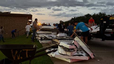 Photo shows pieces of a damaged school roof on the ground after severe storms hit central Kansas on Wednesday, Sept. 3, 2025.