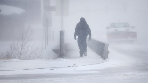 A man crosses Crow Creek during Winter Storm Ulmer on Wednesday March 13 2019 in Cheyenne Wyoming Jacob BykThe Wyoming Tribune Eagle via AP