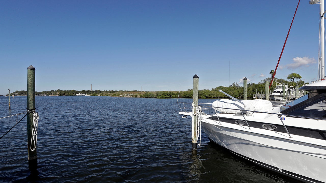 Boats are shown moored in the Anclote River near the old Stauffer chemical plant site in Tarpon Springs, Florida. Hundreds of the nation's most polluted places are at an increasing risk of spreading contamination beyond their borders by more frequent storms and rising seas. (AP Photo/Chris O'Meara)