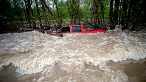 Tittabawassee Fire and Rescue rescued the driver from this red pickup truck on Norh Gleaner Road near its intersection with Tittabawassee Road on Tuesday, May 19, 2020 in Saginaw County, Mich. The truck was swept off of the road by standing water. (Jake May/The Flint Journal via AP)/