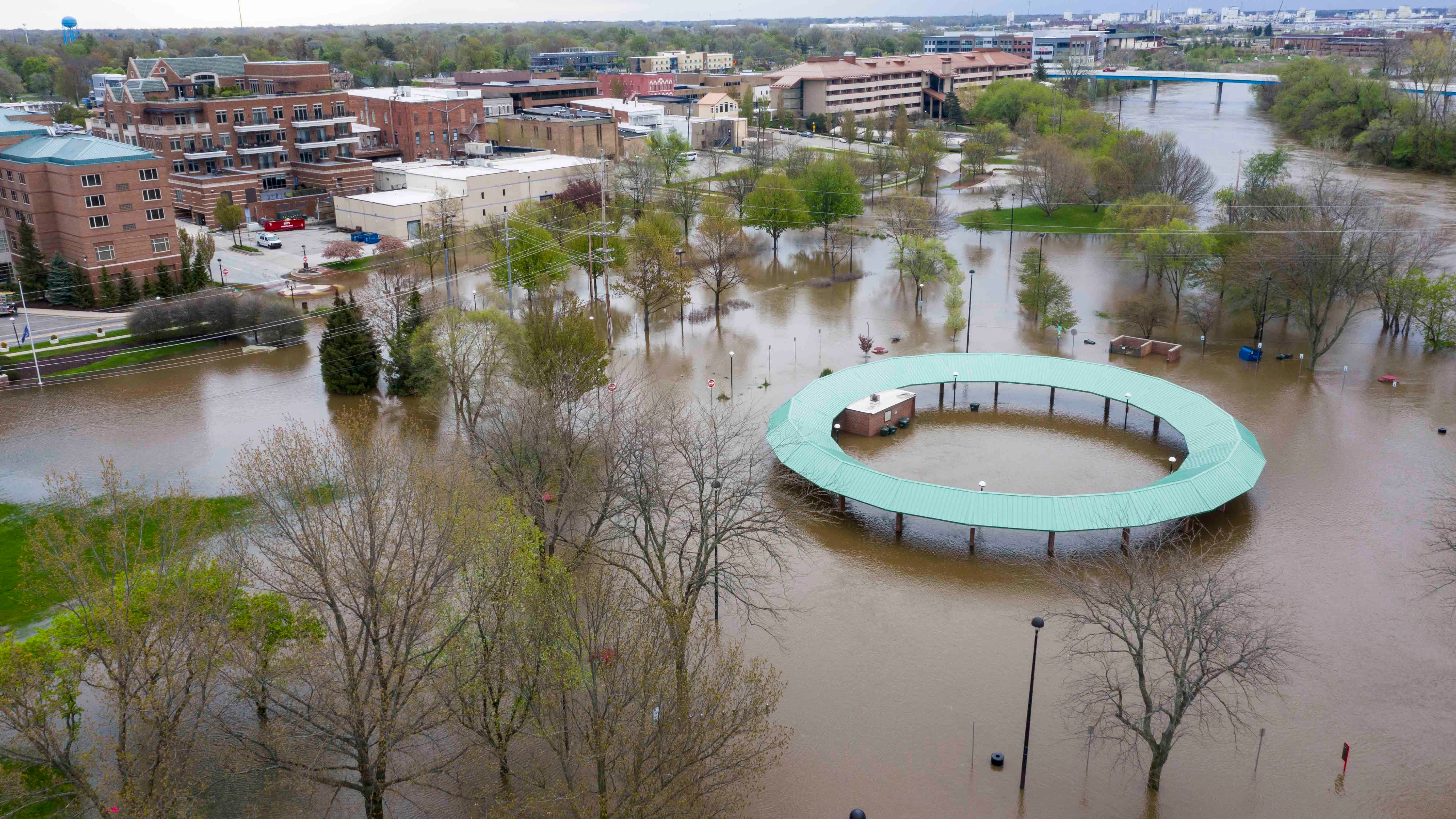 Water floods the Midland Area Farmers Market and the bridge along the Tittabawassee River in Midland, Mich. on Tuesday, May 19, 2020. (Kaytie Boomer/MLive.com/The Bay City Times via AP)
