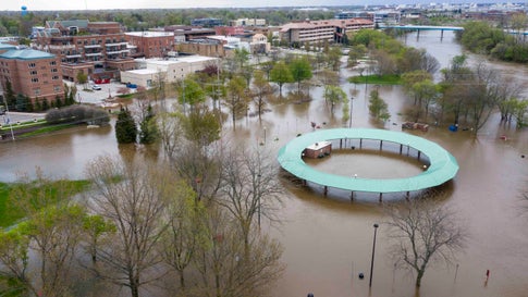 Water floods the Midland Area Farmers Market and the bridge along the Tittabawassee River in Midland, Mich. on Tuesday, May 19, 2020. (Kaytie Boomer/MLive.com/The Bay City Times via AP)