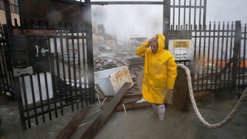 Jame Rowles examines the damage after the docks at the marina where his boat was secured were destroyed as Hurricane Hanna made landfall, Saturday, July 25, 2020, in Corpus Christi, Texas. (AP Photo/Eric Gay)