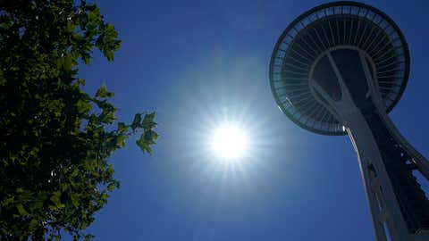 The sun shines near the Space Needle, Monday, June 28, 2021, in Seattle. Seattle and other cities broke all-time heat records over the weekend, with temperatures soaring well above 100 degrees Fahrenheit. (AP Photo/Ted S. Warren)