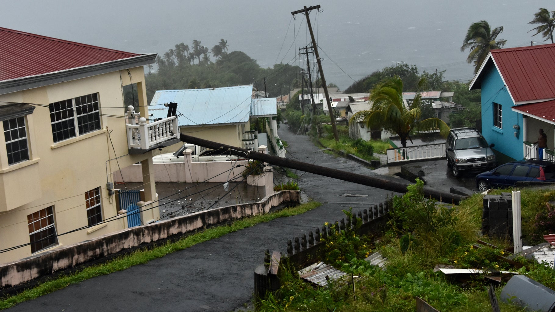 An electrical pole felled by Hurricane Elsa leans on the edge of a residential balcony in Cedars, St. Vincent, Friday, July 2, 2021. (AP Photo/Orvil Samuel)