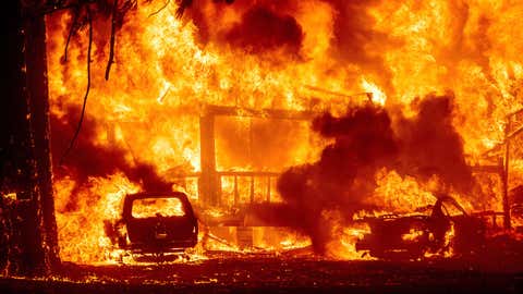 Flames consume a home on Highway 89 as the Dixie Fire tears through the Greenville community of Plumas County, Calif., on Wednesday, Aug. 4, 2021. The fire leveled multiple historic buildings and dozens of homes in central Greenville. (AP Photo/Noah Berger)