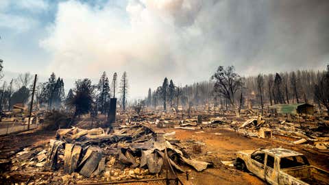 This photo shows cars and homes destroyed by the Dixie Fire line central Greenville on Thursday, Aug. 5, 2021, in Plumas County, Calif. (AP Photo/Noah Berger)