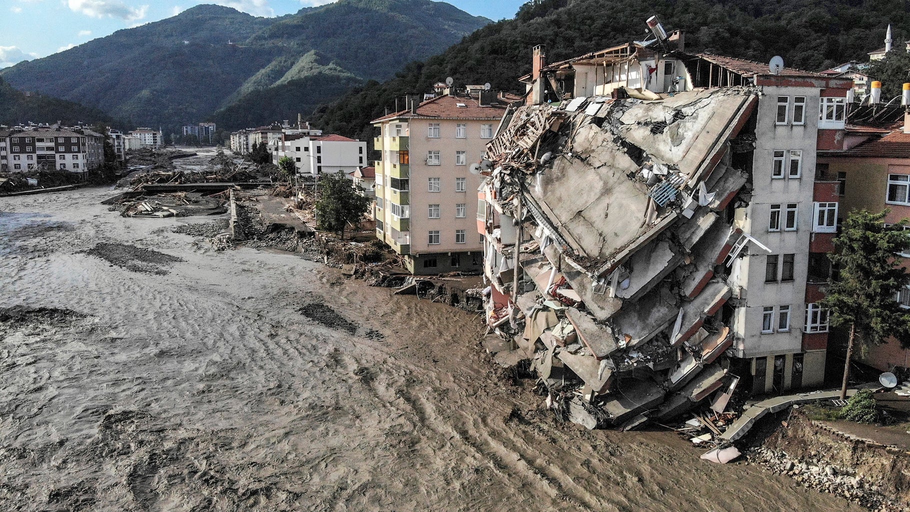 An aerial photo shows destroyed buildings after floods and mudslides killed dozens of people, in Bozkurt town of Kastamonu province, Friday, Aug. 13, 2021. (Ismail Coskun/IHA via AP)