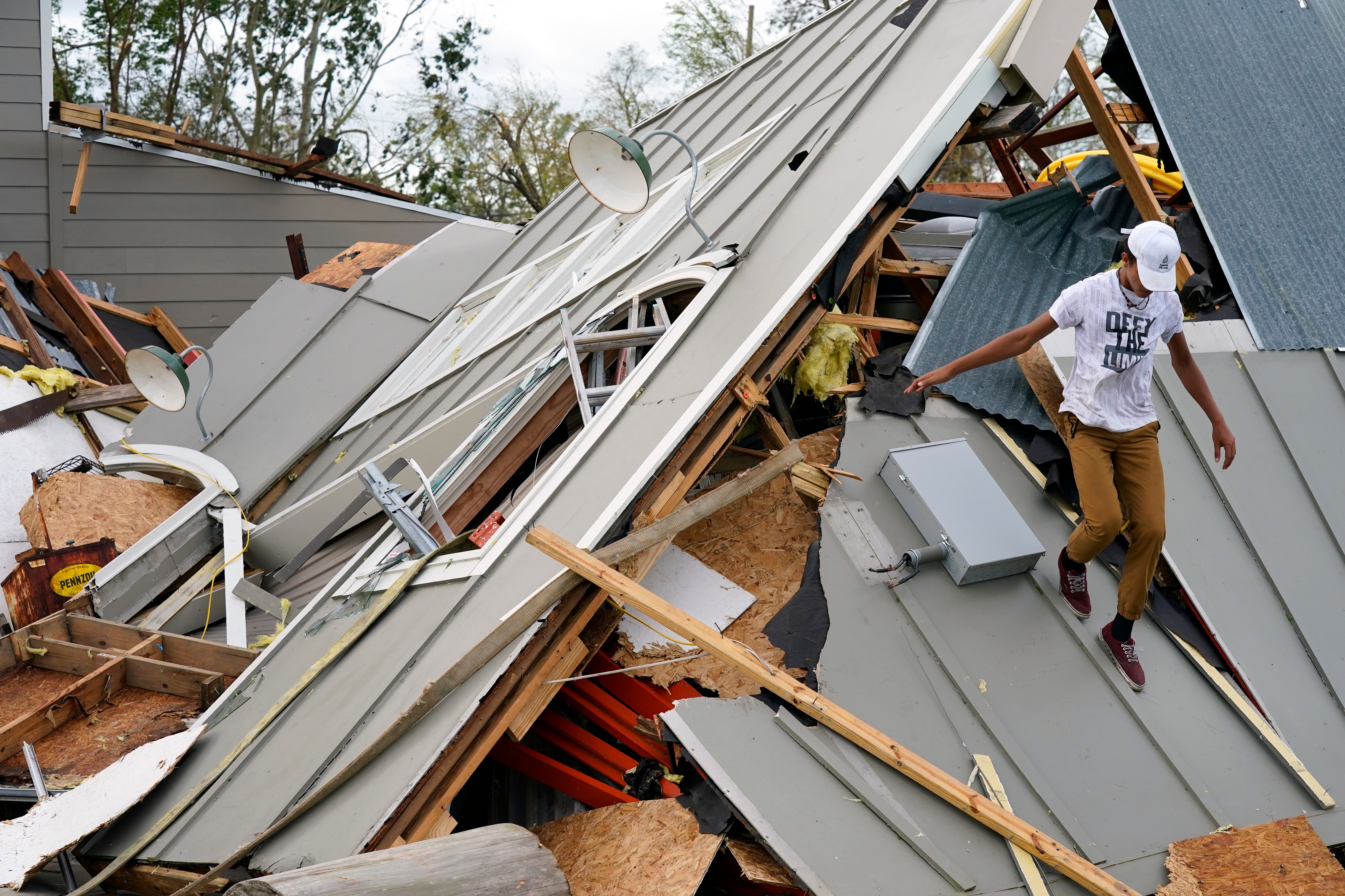 Jeremy Hodges walks onto of their family storage unit in the aftermath of Hurricane Ida, Monday, Aug. 30, 2021, in Houma, La. (AP Photo/David J. Phillip)