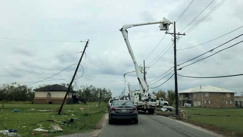 Utility crews work to restore power in rural Terrebonne Parish, La., on Wednesday, Sept. 8, 2021. Ten days after Hurricane Ida hit the state, many in southeast Louisiana remained without electricity. (AP Photo/Kevin McGill)