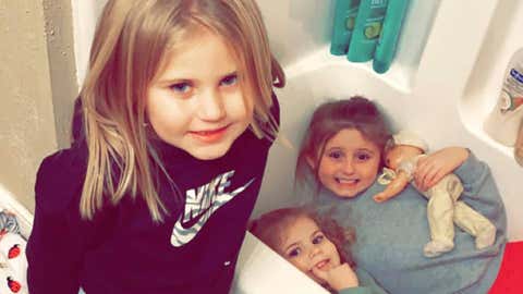 In this Dec. 10, 2021, photo provided by Sandra Hooker, from left, Avalinn Rackley, 7, Alanna Rackley, 3, and Annistyn Rackley, 9, pose for a picture in a bathroom in their home near Caruthersville, Missouri. Annistyn, a third-grader who loved swimming, dancing and cheerleading, was among dozens of people who died because of the severe storm on Friday, Dec. 10. A tornado hit her home and splintered it less than a week after the family had moved in, and, according to the relative who received the photo of the girl in the bathtub, it carried family members dozens of yards before dropping them in a muddy field. (Meghan Rackley/Courtesy of Sandra Hooker via AP)