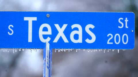 Ice forms on a Texas street sign in Richardson, Texas, Thursday, Feb. 3, 2022. (AP Photo/LM Otero)