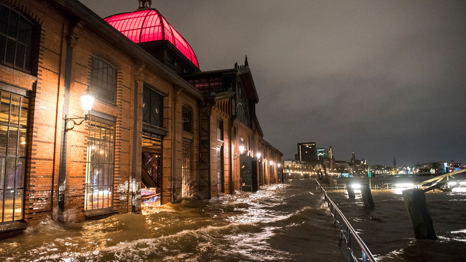 The fish market is flooded during Storm Dudley in Hamburg, Germany, Thursday, Feb. 17, 2022. (Daniel Bockwoldt/dpa via AP)