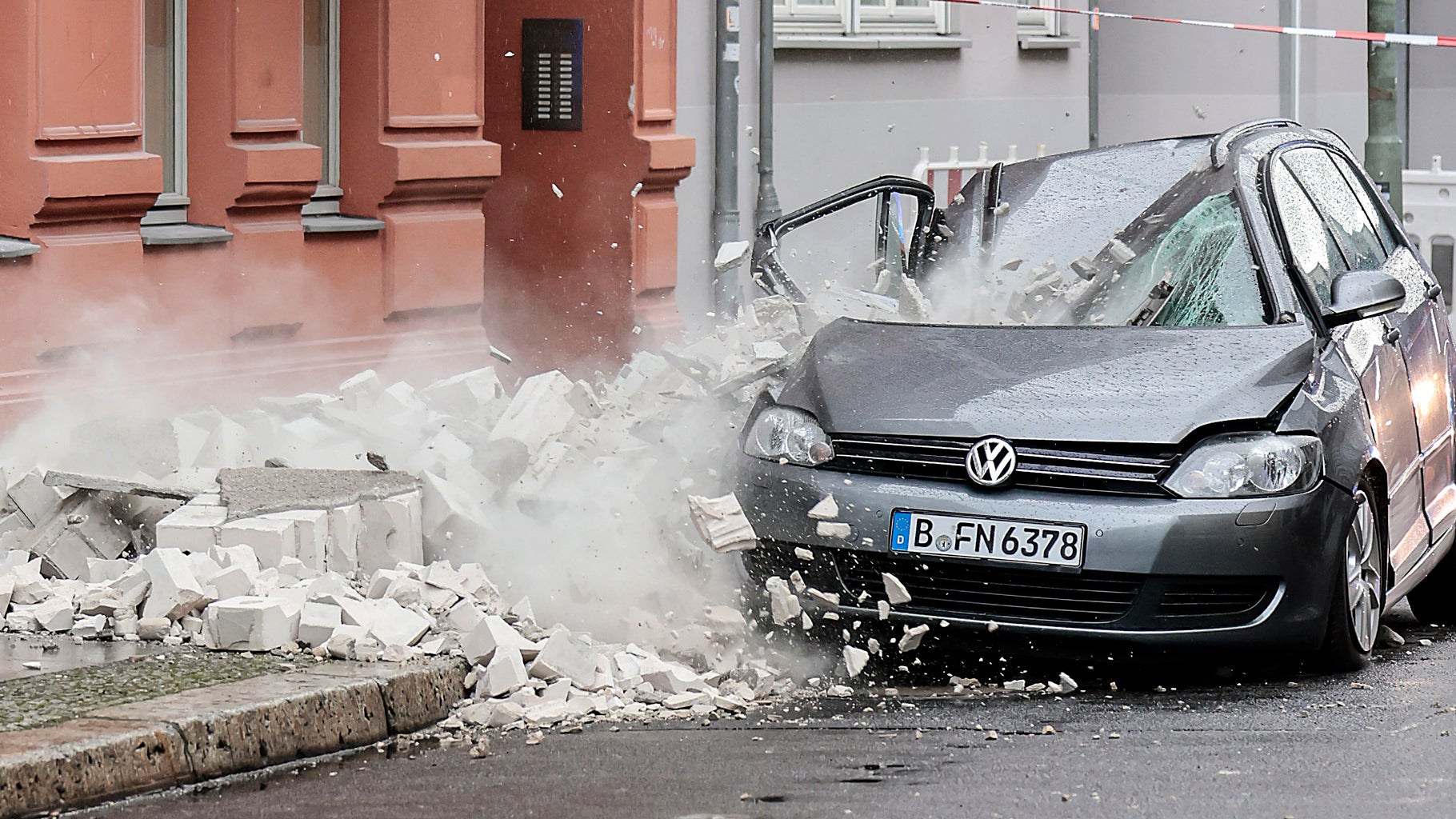 A part of a damaged wall crashed onto the pavement during Storm Dudley in Berlin, Germany, Thursday, Feb. 17, 2022. (AP Photo/Hannibal Hanschke)