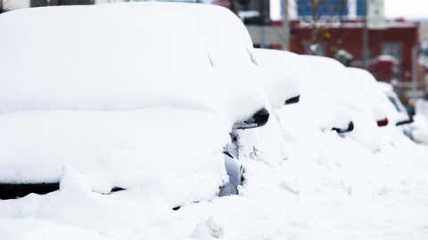 Cars covered in snow are seen downtown Friday, Nov. 18, 2022, in Buffalo, New York. (AP Photo/Joshua Bessex)