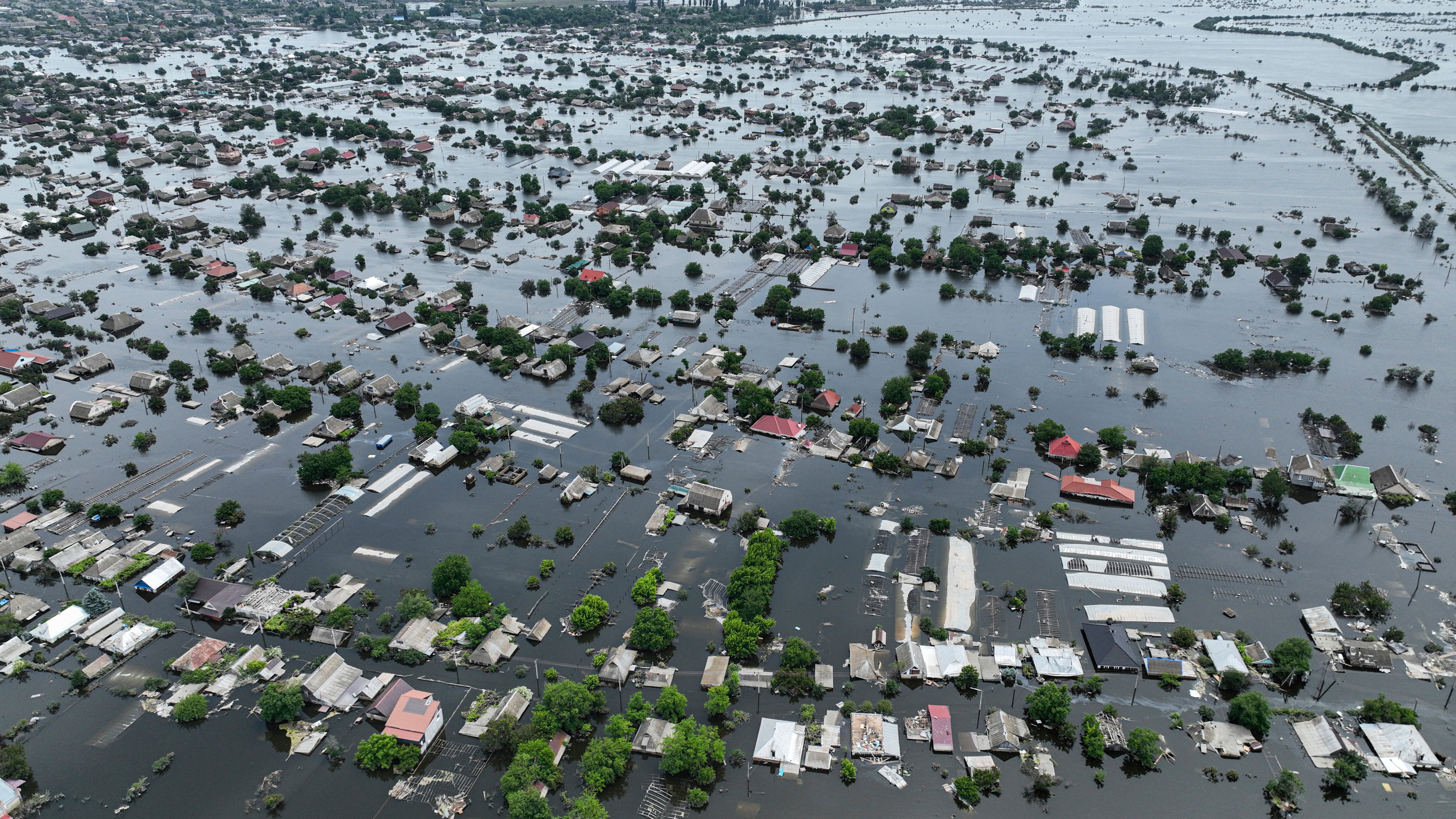 Houses are seen underwater in the flooded town of Oleshky, Ukraine, Saturday, June 10, 2023. The destruction of the Kakhovka Dam in southern Ukraine is swiftly evolving into long-term environmental catastrophe. It affects drinking water, food supplies and ecosystems reaching into the Black Sea.  (AP Photo)
