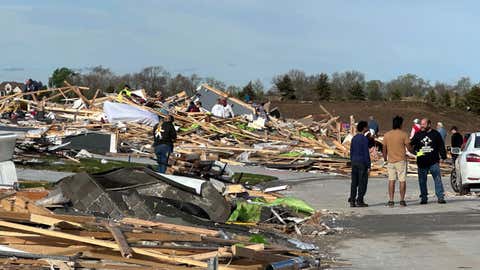 People are pick through the rubble of a house that was leveled in Elkhorn, Neb., on Saturday, April 27, 2024. Residents began sifting through the rubble after a tornado plowed through suburban Omaha, demolishing homes and businesses as it moved for miles through farmland and into subdivisions. (AP Photo/Nicholas Ingram)