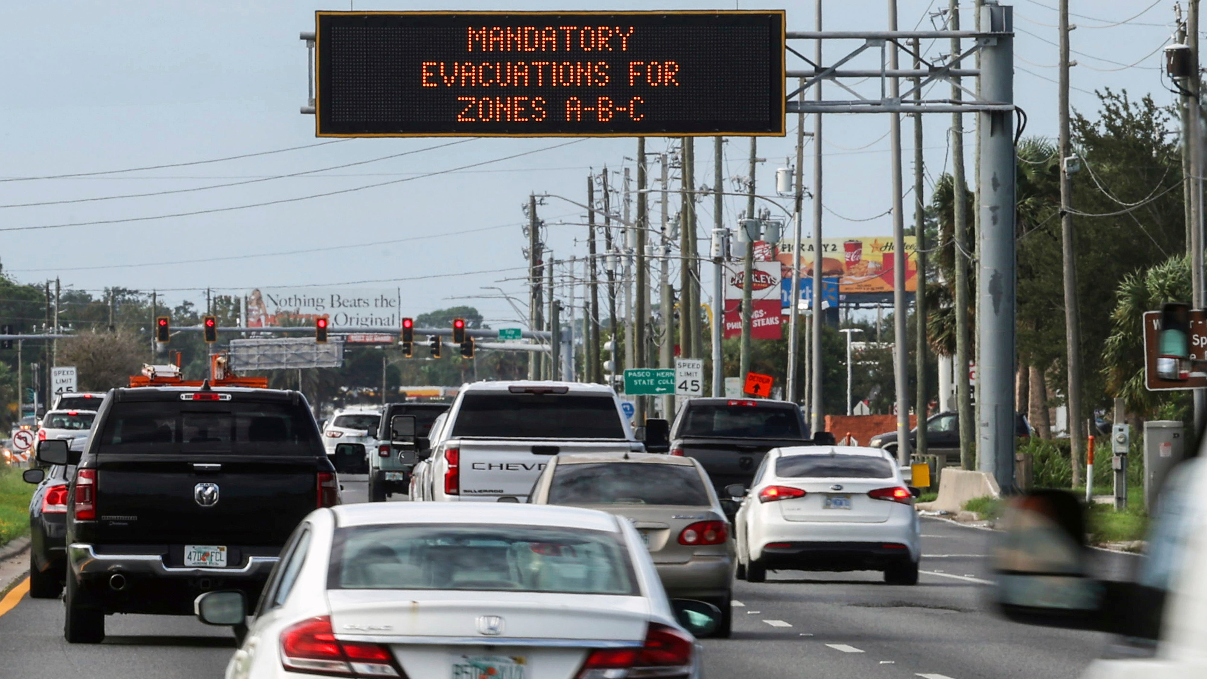 Highway signage announces the impending arrival of Hurricane Milton and the evacuations zones on Tuesday, Oct. 8, 2024, in Port Richey, Fla. (AP Photo/Mike Carlson)