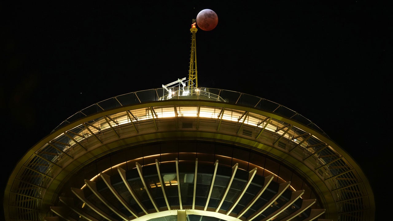 A total lunar eclipse is seen over the Space Needle, Thursday, March 13, 2025, in Seattle. (AP Photo/Lindsey Wasson)
