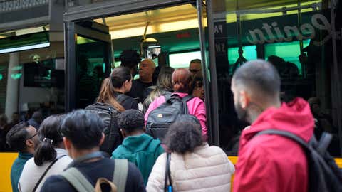 People try to board a crowded bus after the subway stopped running following a power outage in Lisbon, Portugal, Monday, April 28, 2025. (AP Photo/Armando Franca)