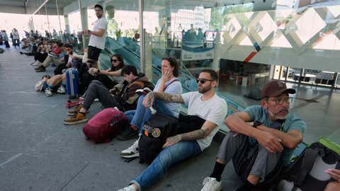 Passengers wait outside Atocha train station during a nationwide power outage in Madrid on Monday, April 28, 2025. (AP Photo/Manu Fernandez)