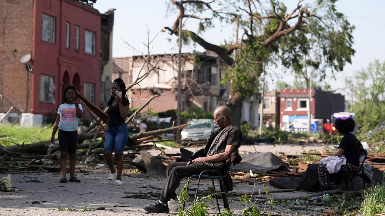A man sits in a chair after a severe storm moved through St. Louis, Missouri, Friday, May 16, 2025. (AP Photo/Jeff Roberson)