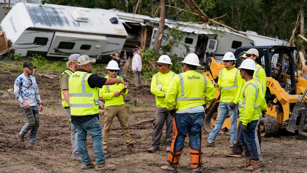 People help during clean-up efforts at Guadalupe Keys Resort, an RV park in Center Point, Texas, after flooding, Monday, July 7, 2025. (AP Photo/Ashley Landis)