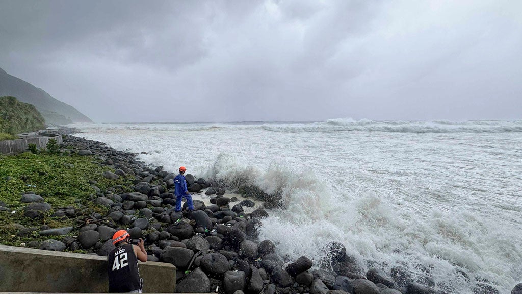 People watch as strong waves batter Basco, Batanes province, northern Philippines as Typhoon Ragasa affects the area on Monday, Sept. 22, 2025. (AP Photo/Justine Mark Pillie Fajardo)