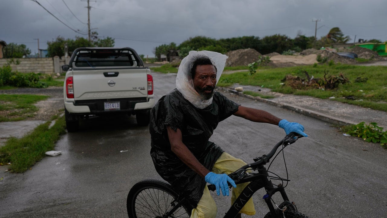A man rides a bicycle ahead of the forecast arrival of Hurricane Melissa in Kingston, Jamaica, Sunday, Oct. 26, 2025. (AP Photo/Matias Delacroix)