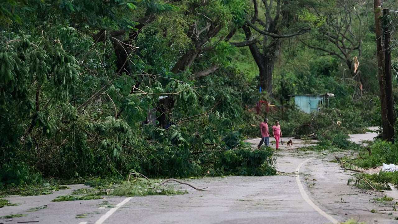 People walk along a road after Hurricane Melissa passed through Spurr Tree, Jamaica, Wednesday, Oct. 29, 2025. (AP Photo/Matias Delacroix)